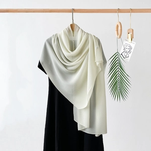 Close-up of cream white pleated chiffon shawl with elegant drape and texture