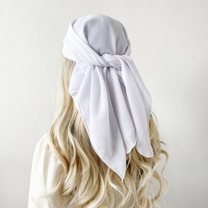 Rear view of white chiffon square headscarf tied on long blonde curly hair