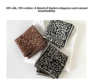 Detailed texture of leopard print silk scarves in coffee, grey, and black colorways