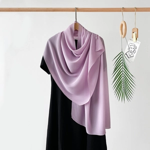 Detail showing the pleated texture and drapery of a purple chiffon long scarf on a hanger