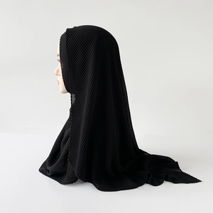 Detail view of black pleated chiffon hijab showing fine vertical accordion textures