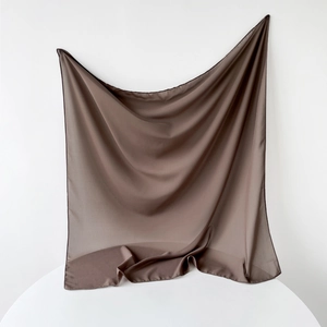 Detailed view of dark brown square chiffon scarf with elegant drapes and silky texture