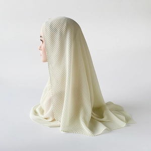 Detail of light beige pleated chiffon hijab with elegant wavy edge and high density texture