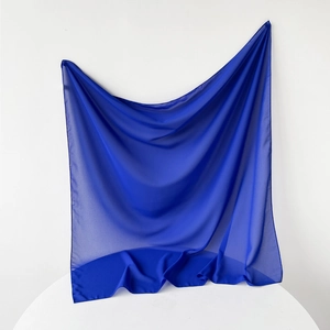 Detailed texture of royal blue pearl chiffon headscarf with smooth fabric draping
