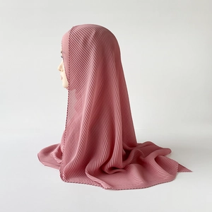 Detailed view of dusty rose pleated chiffon hijab with fine vertical texture on model