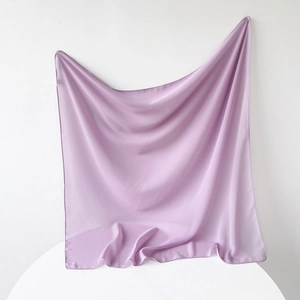 Detail of lavender chiffon square scarf with smooth texture and delicate rolled hem