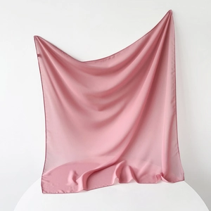 Detail view of dusty rose square chiffon hijab showing fine edge stitching and smooth texture