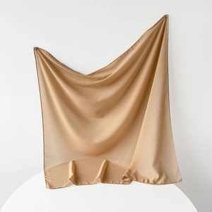 Detailed view of champagne satin square scarf with premium rolled hem edges