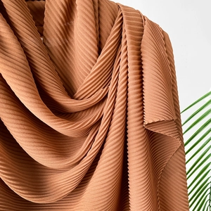 Terracotta pleated silk-like scarf with fine crinkle texture and soft drape