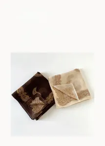 Detail of hollowed-out paisley silk scarf with delicate floral patterns and sheer texture