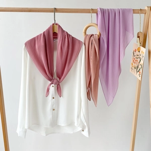 Detail of pleated chiffon hijab scarves in pastel pink and purple showing texture and drape