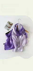 Detail of elegant gradient purple satin scarf hanging gracefully on a wooden hanger