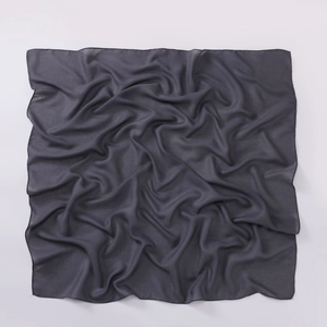 Detail of dark grey cotton linen square scarf showing fine plain weave texture and hemmed edges