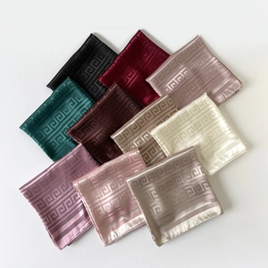 Detail of ten colorful faux silk square scarves featuring a classic Greek meander pattern