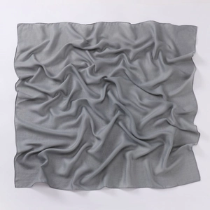 Detailed texture of gray solid cotton linen square scarf with natural soft fabric folds