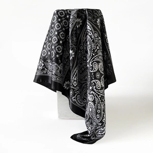Detail van een premium zijdeachtige vierkante sjaal met zwart-wit paisley patroon