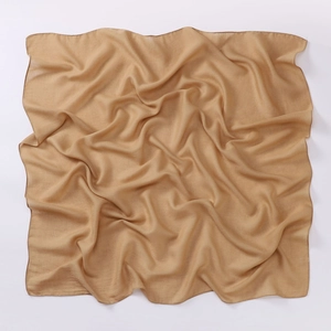Detailed close-up of camel cotton linen square scarf showing soft texture and premium hem