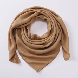 Detail shot of camel cotton linen scarf showing soft drape and fine fabric texture