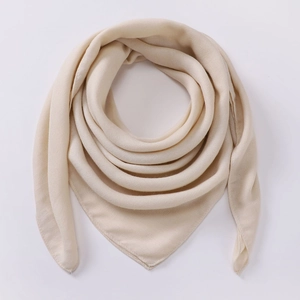 Detail of premium beige cotton linen square scarf showing soft texture and fine stitching