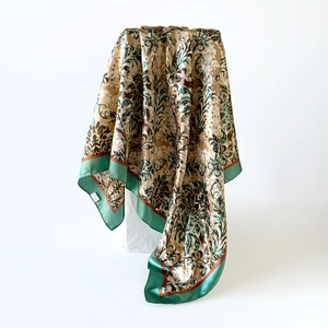 Detailed macro view showing the glossy satin fabric and intricate baroque floral pattern