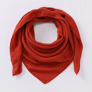 Detailed macro view of the rust red cotton linen scarf texture and neat edge craftsmanship