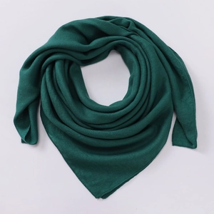Detail of dark green lightweight fabric scarf with fine rolled edges and micro-grain texture