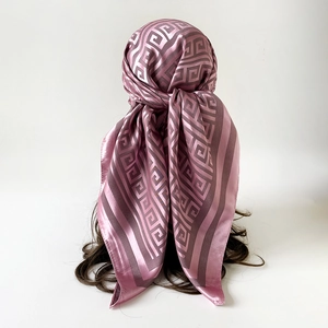 Detailed back view of a dusty rose satin scarf with classic Greek key pattern on hair