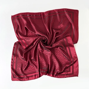 Detailed view of dark burgundy silk square scarf with Greek key pattern and satin finish