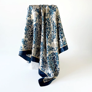 Detail of luxury satin square scarf with dark blue damask floral pattern and silk finish
