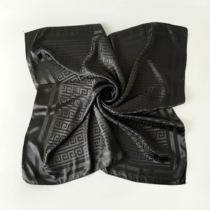 Detail of elegant black silk square scarf featuring classic Greek meander pattern prints