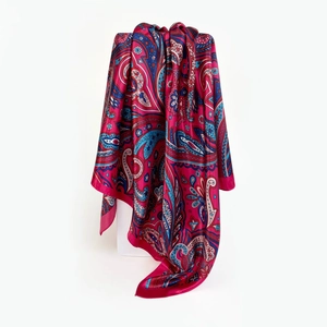 Detail of fuchsia paisley satin scarf showing smooth texture and intricate floral pattern