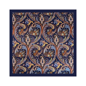 Detailed view of intricate paisley patterns on silk scarf with vibrant orange and blue tones