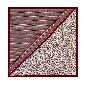 Detailed pattern showing geometric herringbone design and flying bird print on silk scarf