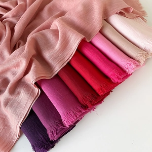 Close-up of gradient pink and purple cotton linen scarves with soft fringe details