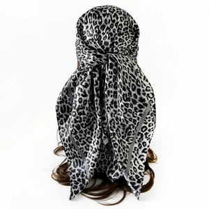 Close-up of black and grey leopard print satin headscarf with wide dark grey borders