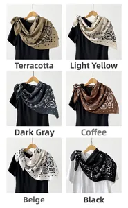 Detail view of 90cm paisley silk scarves in khaki, brown, beige, and black color options