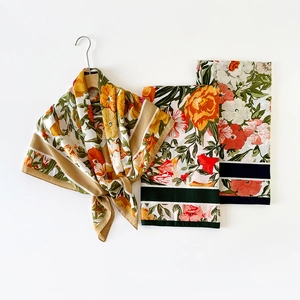 Detail of vintage floral pattern silk scarves in orange and green with smooth texture