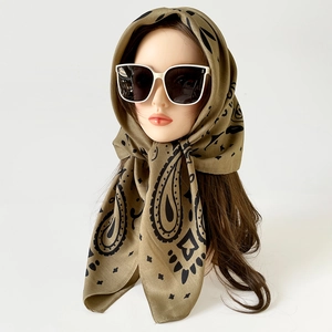 Olive green paisley satin headscarf and retro white oversized sunglasses on display