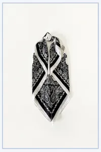Detail of satin square scarf featuring vintage black and white paisley patterns