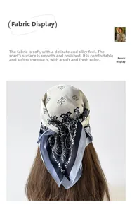 Detailed view of beige and navy paisley silk-like scarf tied in a ponytail as hair tie