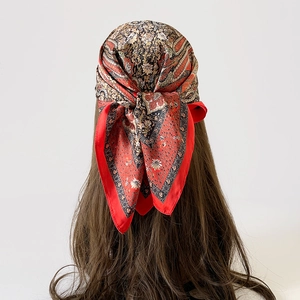 Detailed back view of vintage paisley satin scarf tied elegantly as a bohemian headpiece