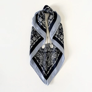 Detail of elegant navy paisley satin square scarf featuring vintage floral patterns