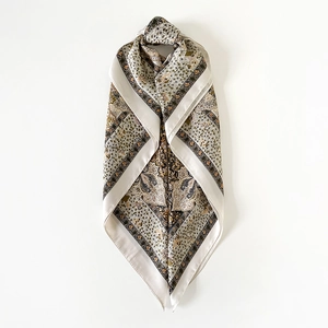 Detailed macro view of retro paisley print on smooth satin silk square scarf fabric