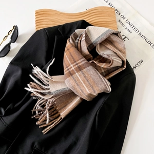 Classic brown plaid tassel scarf layered on a blazer with stylish accessories