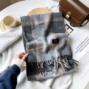 Close-up of classic British checkered cashmere scarf with elegant tassels and soft texture