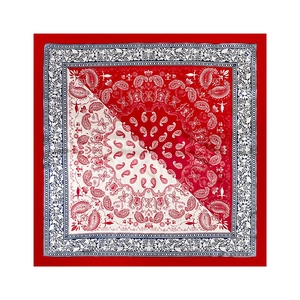 Flat lay of red and white paisley pattern silk scarf with elegant floral border detail