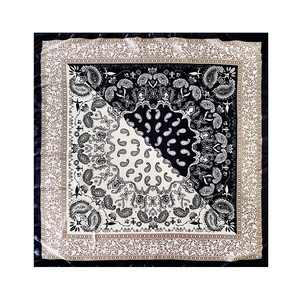 Classic black and white paisley print square silk scarf on dark velvet background