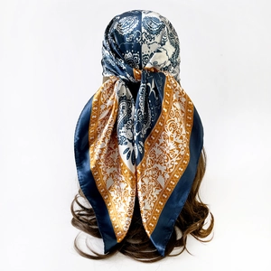 Styling of 90cm paisley silk scarf on model showing luxurious satin texture and patterns