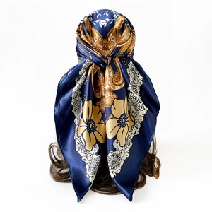 Detail of silk-like satin headscarf with gold floral pattern on deep blue background