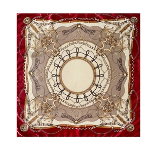 Detailed view of the luxury chain and floral patterns on the burgundy silk satin scarf